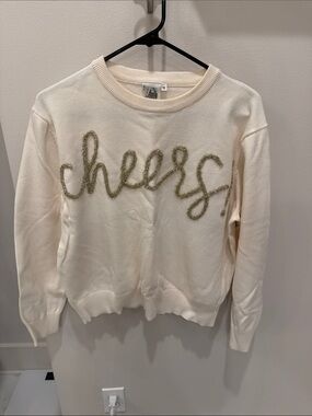 QUEEN OF SPARKLES Cream Crewneck Sweater with Gold 'cheers' Script